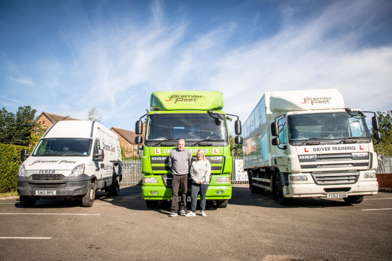 Paul and Sarah Martin standing in front of PFS Training vehicles