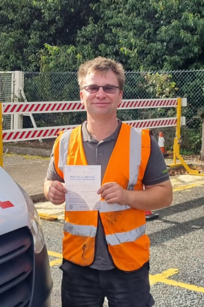 Man holding pass cerificate for HGV Driver Training Category C+E with PFS Training