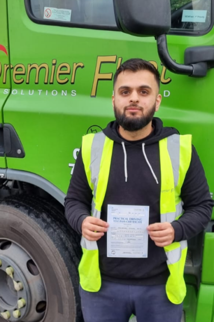 Man holding pass cerificate for HGV Driver Training Category C+E with PFS Training